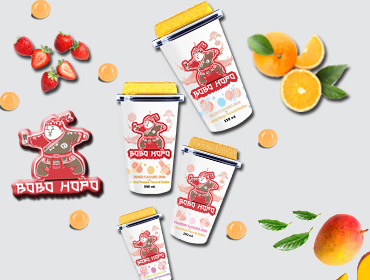 Bobohopo's vibrant assortment of non-alcoholic drinks, featuring melon, orange, tropical, and strawberry flavors, surrounded by fresh fruits.